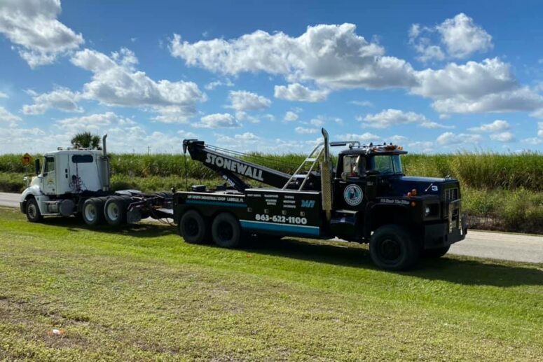 Stone Wall tow truck with a semi truck, without trailer, in tow.